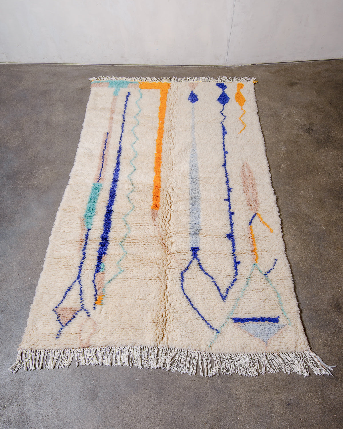 Berberlin Finest Rug made of plush wool laying flat on concrete floor.